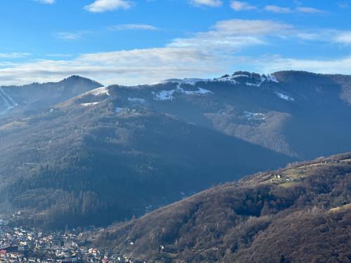a view of a mountain valley with a city and a lake at Садиба Трембіта з сауною та чаном in Rakhiv