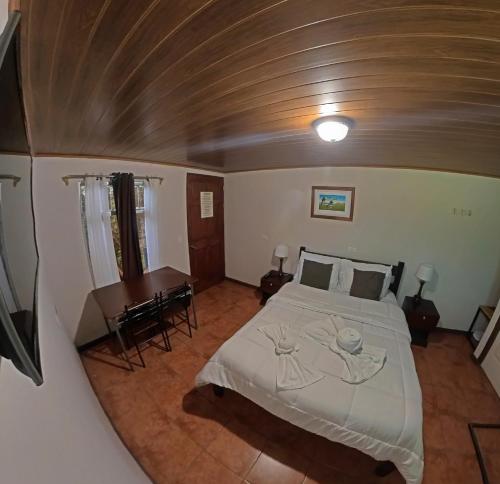 a bedroom with a bed and a table in it at Casa Jungle Monteverde B&B in Monteverde Costa Rica