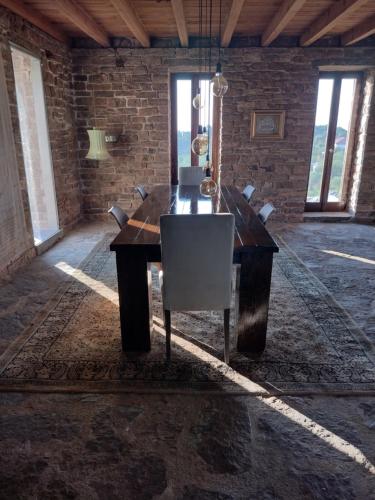 a wooden desk in a room with chairs at Raphale in Preveza