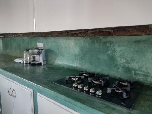 a green counter top with a stove in a kitchen at Raphale in Preveza