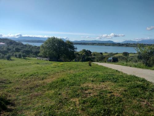 a road leading to a field with a view of a lake at Raphale in Preveza
