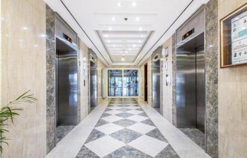a hallway in a building with a checkered floor at Full sea view Studio high floor in Ras al Khaimah