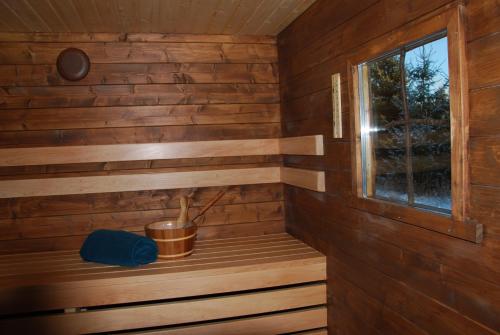 a sauna with a window in a wooden cabin at Kuusehaldja Glamping in Kohila