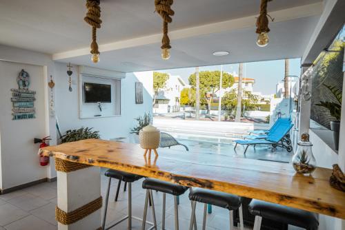 a dining room with a wooden table and chairs at Tsolias Apartments in Protaras