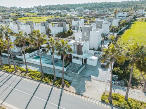 an aerial view of a building with palm trees at Tsolias Apartments in Protaras