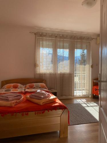 a bedroom with a bed and a large window at Bisa in Soko Banja