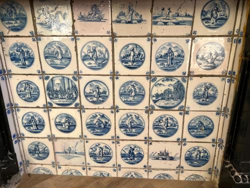 a wall with blue and white plates on it at Boutique Hotel de Kade Zaandam-Amsterdam in Zaandam