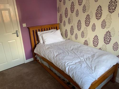 a small bed in a room with a wall at Huntingdon walk to town centre, cosy, Free parking in Huntingdon