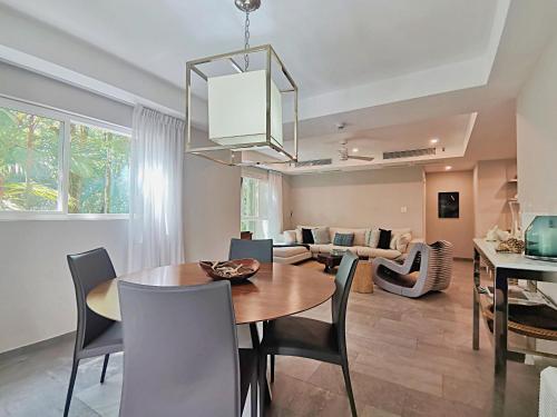 a dining room and living room with a table and chairs at Elan at Ballena Beach in Uvita
