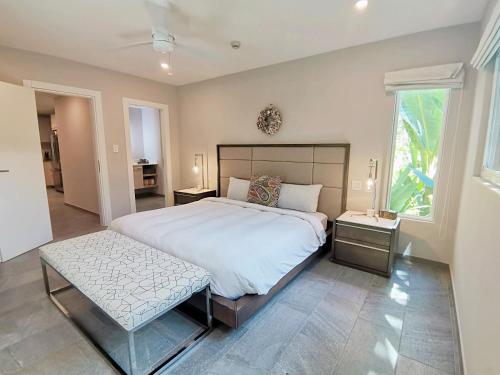 a large bedroom with a large bed and two tables at Elan at Ballena Beach in Uvita