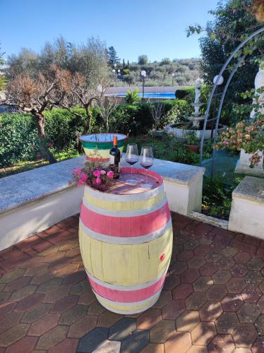 a barrel table with wine glasses on a patio at Trullo Nonna Rosa in Antonelli