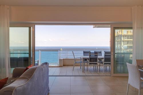 a living room with a view of the ocean at Seafront Apartment Sliema in Sliema