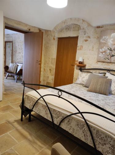 a bedroom with a large bed in a room at Trullo Nonna Rosa in Antonelli