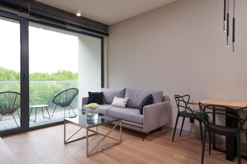 a living room with a couch and a table at Apartamenty Olimpijska by RENT4YOU in Olsztyn