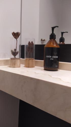 a counter with three bottles of soap on it at Duplex premium, excelente ubicacion II in Yerba Buena