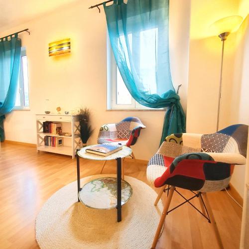 a living room with two chairs and a table at Il Portico Rosa in Cuglieri