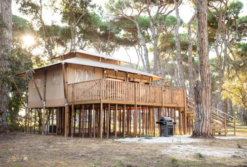a house being built in the middle of trees at ISOLA VERDE Camping Village in Nettuno
