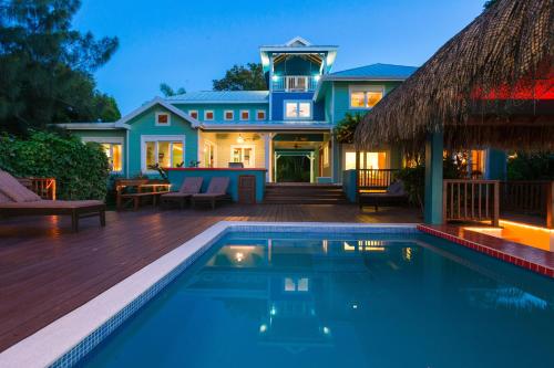 a house with a swimming pool in front of a house at Casa de Suenos Home in Sandy Bay