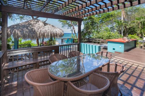 a patio with a table and chairs on a deck at Casa de Suenos Home in Sandy Bay