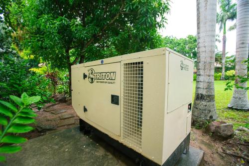 a box sitting on the ground next to a tree at Casa de Suenos Home in Sandy Bay