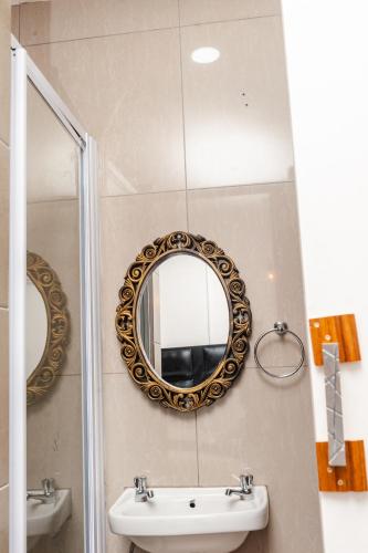 a bathroom with a sink and a mirror at Nkosazana Guest House in Durban