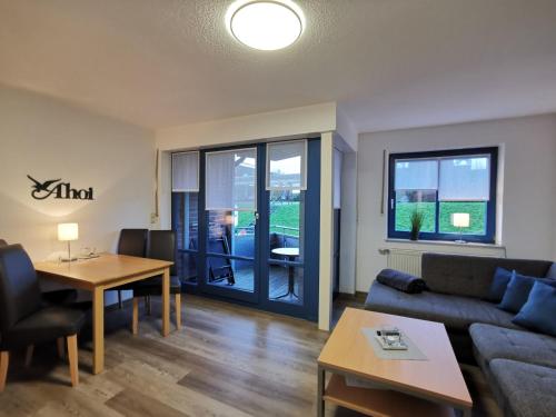 a living room with a couch and a table at Strandsegel in Horumersiel