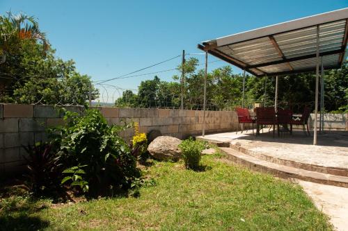 a backyard with a fence and a table and chairs at Nkosazana Guest House in Durban