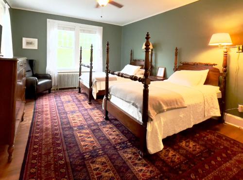 a bedroom with two beds and a rug at Willow 