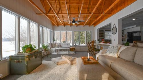 un salon avec un canapé et une table dans l'établissement Scenic & Serene Lakefront Cottage With Wood Stove, à Crivitz