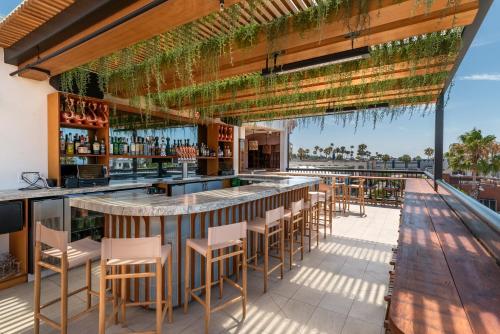 a bar on the roof of a resort with a view at The Brick Boutique Hotel in Oceanside