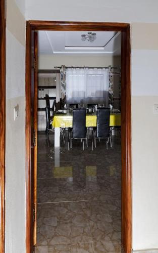 a dining room with a yellow table and chairs at Maison Bethel Kpogan Afidenigba in Azyagbang