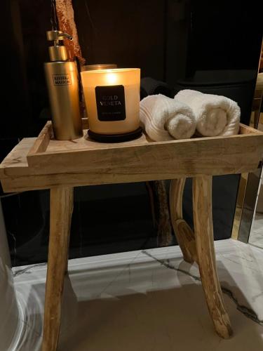 a wooden table with a candle and towels on it at Gold Pearl Zegrze in Serock