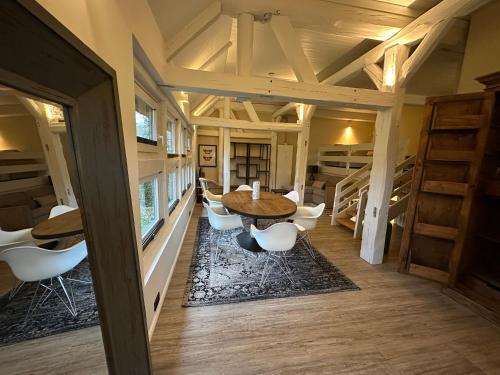a room with a table and chairs in a house at Ferienwohnung St. Dionyser Heidedorf EG7 in Sankt Dionys