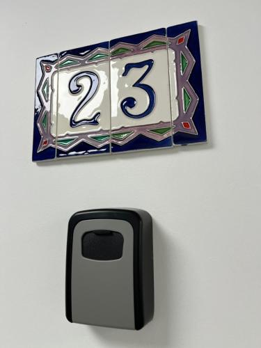 a wall mounted clock with the number on it at Gold Pearl Zegrze in Serock