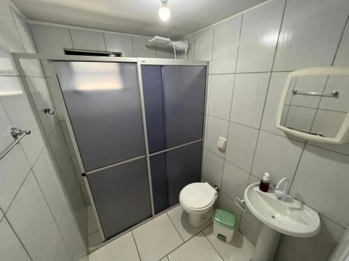 a bathroom with a shower and a toilet and a sink at Casa Suzena 300 metros Parque e Praias in Penha