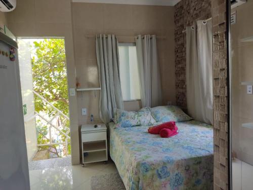 a bedroom with a bed with a pink stuffed animal on it at Pousada Bem-te-vi in Aracaju