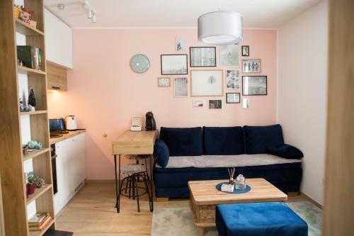 a living room with a blue couch and a table at Nomad Jahorina in Jahorina