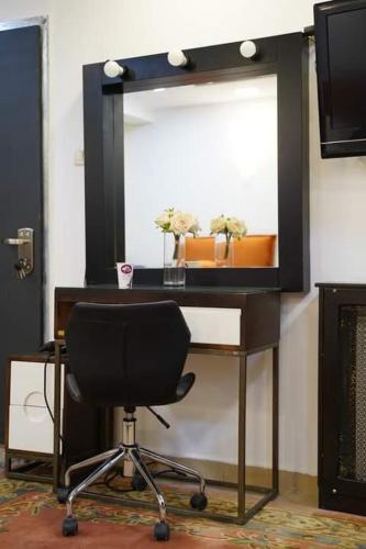 a desk with a chair in front of a mirror at Daniel Studio #1 in Ramallah