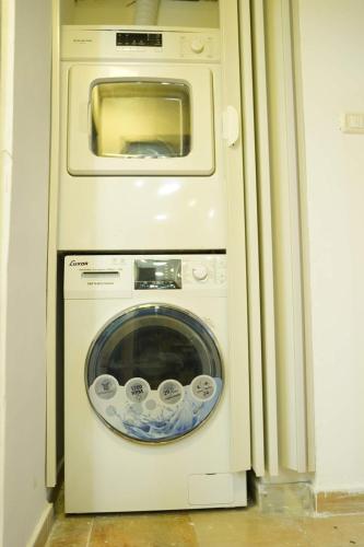 a washing machine with a microwave in a room at Daniel Studio #1 in Ramallah