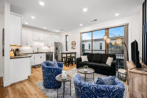 a kitchen and living room with a couch and a table at Urban Escape in Downtown Traverse City in Traverse City