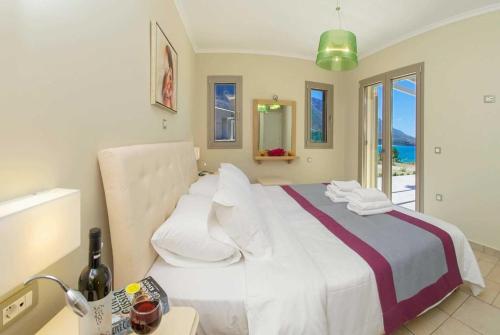 a bedroom with a bed with a view of the ocean at Trapezaki Beach in Trapezaki