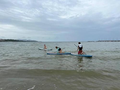 a group of people on paddle boards in the water at Beautiful Apartment in Vista Mar Golf, Beach & Marina in Santa Teresita