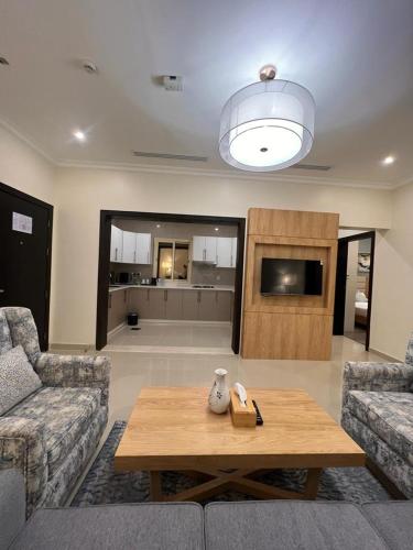 a living room with a couch and a coffee table at Lolia Hotel فندق لوليا الفندقية in Raʼs Tannūrah