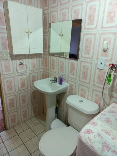 a bathroom with a sink and a toilet and a mirror at Cabañas Matanzas Noemi in Boca Pupuya