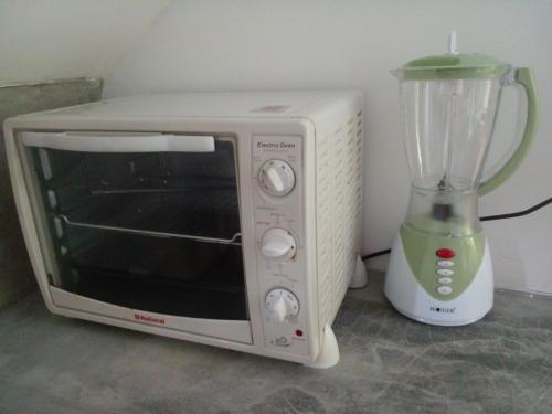 a white microwave next to a blender on a counter at Lake Lane Guest Rest in Koggala