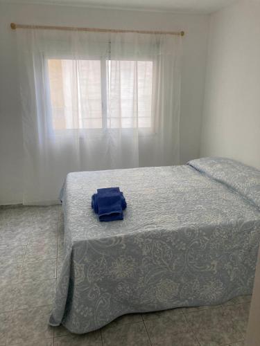 Un dormitorio con una cama con una bolsa azul. en TREJO 817 en Córdoba