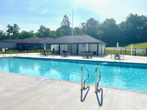 a swimming pool with a deck and a building at Newly Remodeled Mid-Century Modern Lake Condo in Lake Geneva