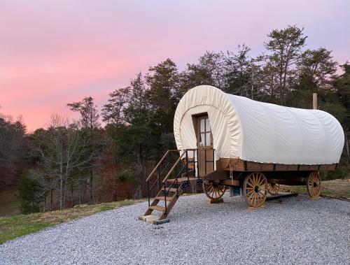 a train car with a tent on a trailer at Smoky Hollow Outdoor Resort Covered Wagon in Sevierville