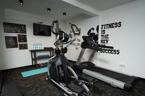 a gym with a treadmill and a bike in a room at MaRadha Colombo in Colombo