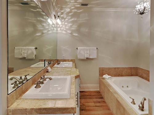 a bathroom with two sinks and a bath tub at Adagio 303E in Santa Rosa Beach